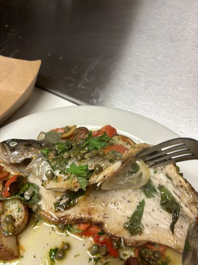 Whole fish with capers — professional kitchen