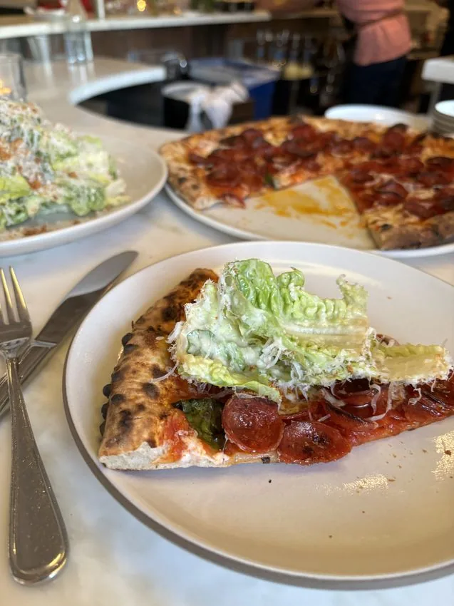 Wood-fired pizza with Caesar — bar seating